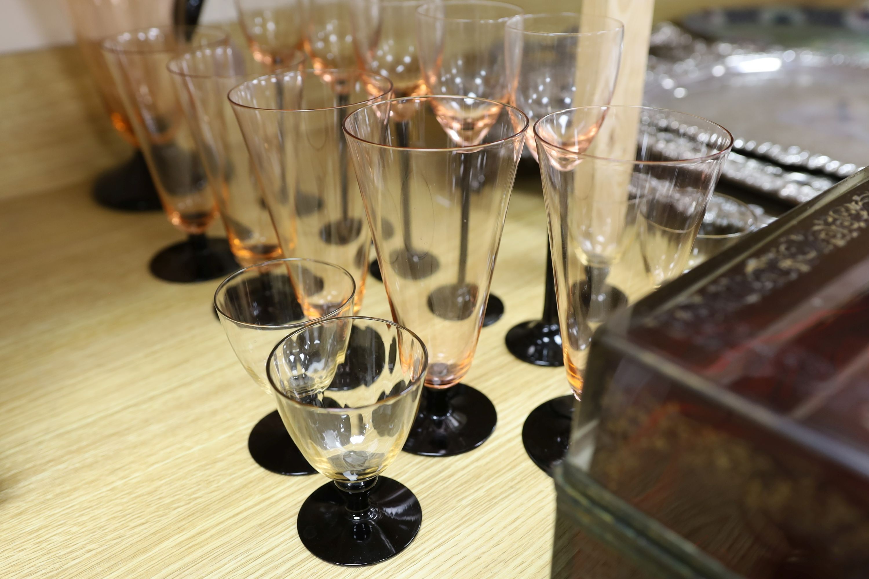 A Bohemian ruby glass casket and an Art Deco style part lemonade set in black and pink glass (14 glasses and a jug)